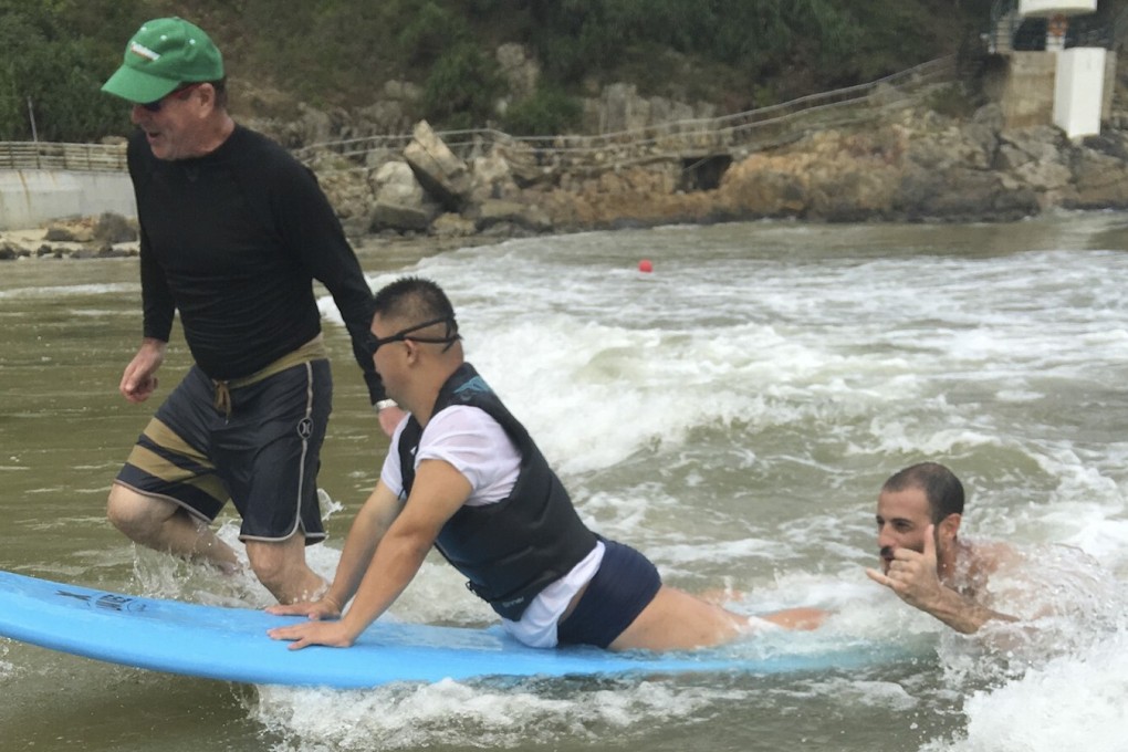 Wai Hang, 32, enjoys a surf at Big Wave Bay in Hong Kong. Wai is one of Love 21 Foundation’s star athletes and takes part in a wide range of free activities. The charity supports people with Down’s syndrome and their families. Photo: Love 21 Foundation