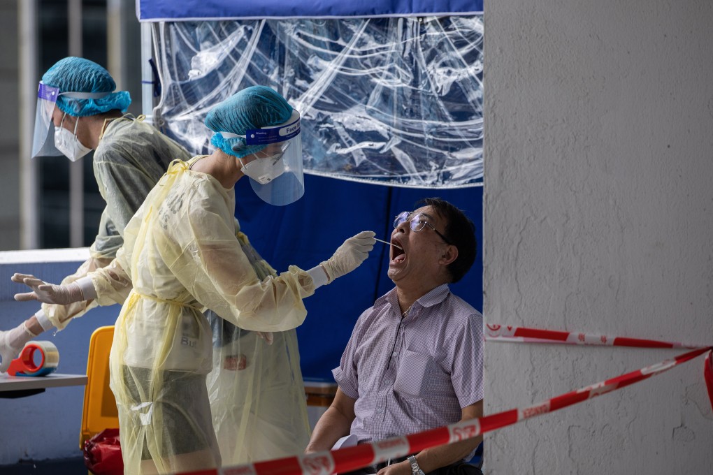 A taxi driver is tested for Covid-19 in a parking lot in Hong Kong. Photo: EPA-EFE