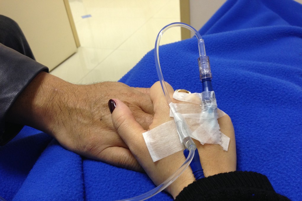 Breast cancer survivor Teresa Tam and her husband, Akio Nishida, share a special moment during her last therapy session in 2013. Photo: Teresa Tam
