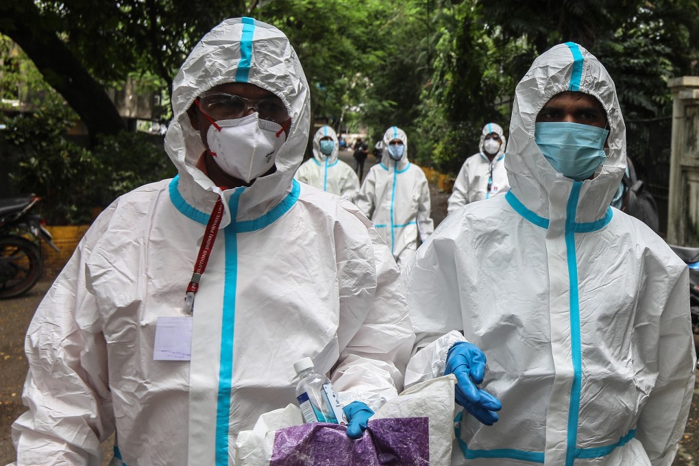 Indian health care workers wear personal protective equipment to conduct Covid-19 tests. Many have complained of uncomfortable working conditions and poor treatment from patients and members of the public. Photo: EPA-EFE