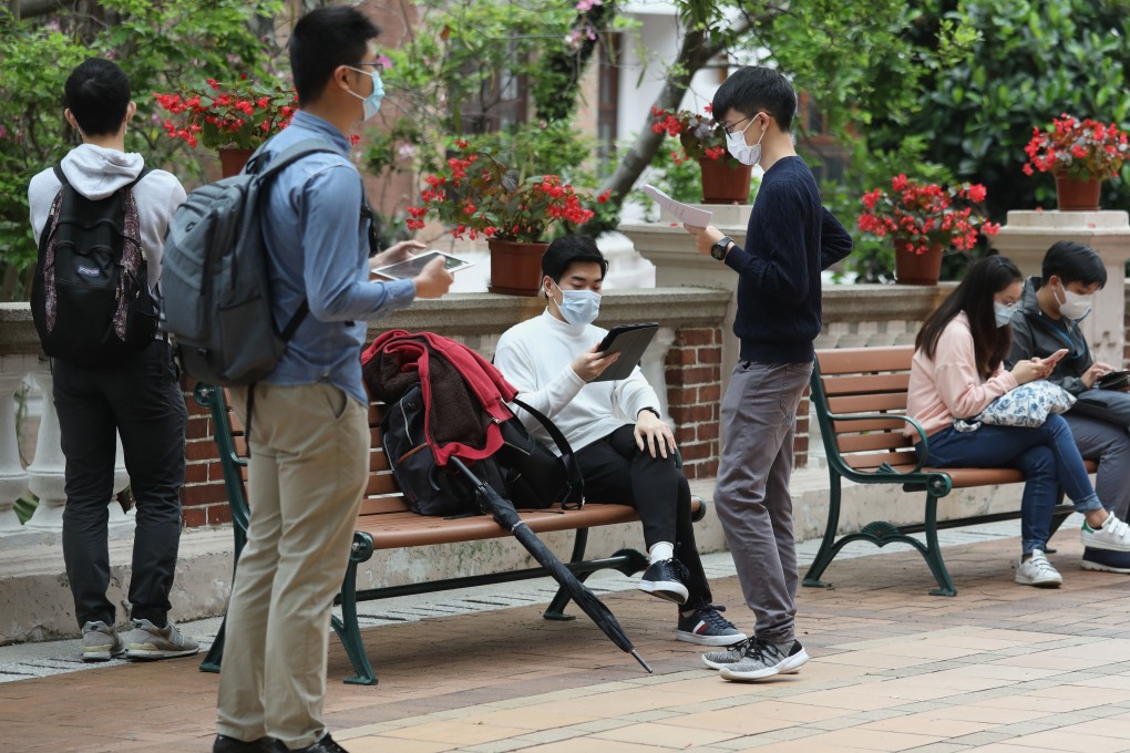 Students with face masks look through their notes at the University of Hong Kong campus in Pok Fu Lam on April 1. Photo: Nora Tam