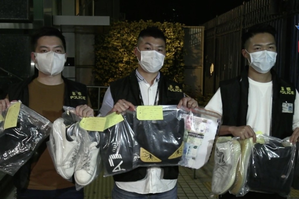 Police officers display evidence taken from four men, including three underage students, arrested in connection to an attack on a restaurant owner in Yuen Long. Photo: Facebook