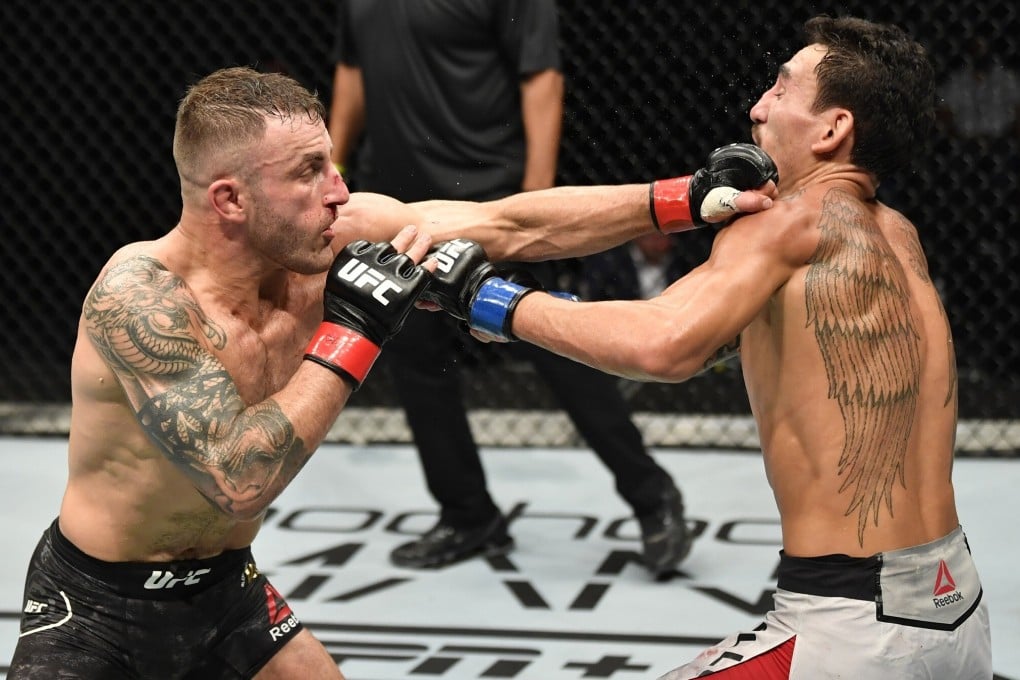 Alexander Volkanovski punches Max Holloway in their featherweight championship fight during UFC 251 at Flash Forum on UFC Fight Island in Abu Dhabi. Photo: Jeff Bottari/Zuffa LLC