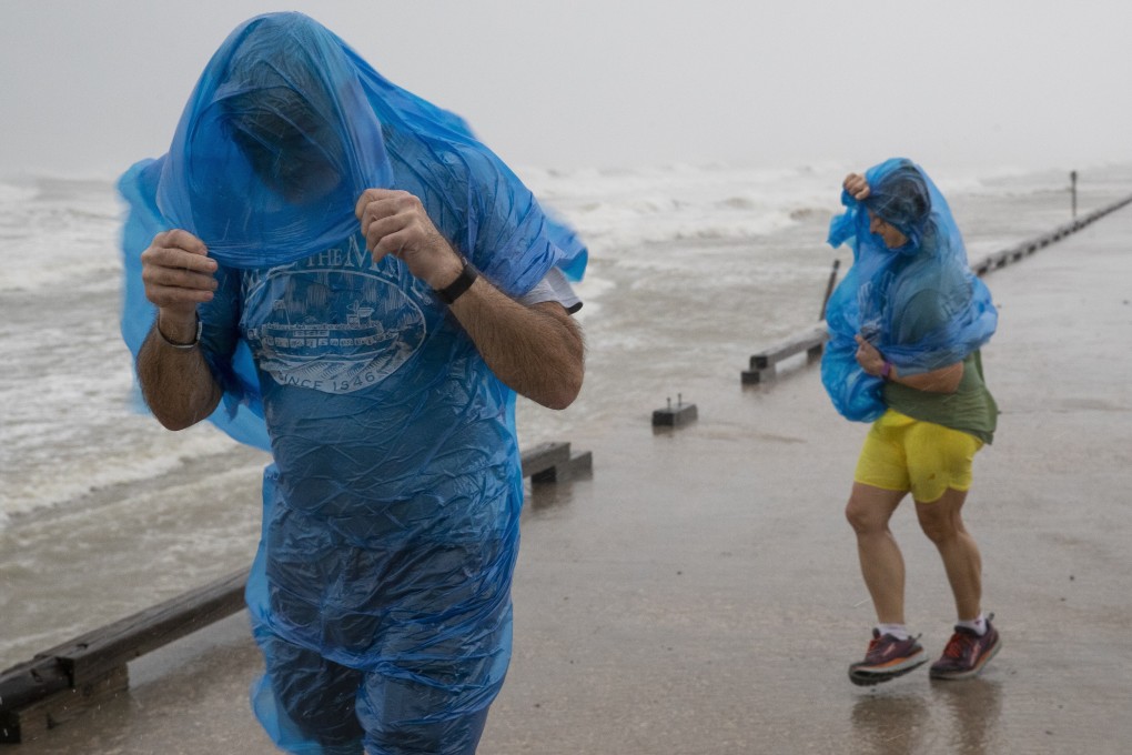 People walk along the sea wall at Whitecap beach to watch as Hurricane Hanna approaches. Photo: Corpus Christi Caller-Times via AP