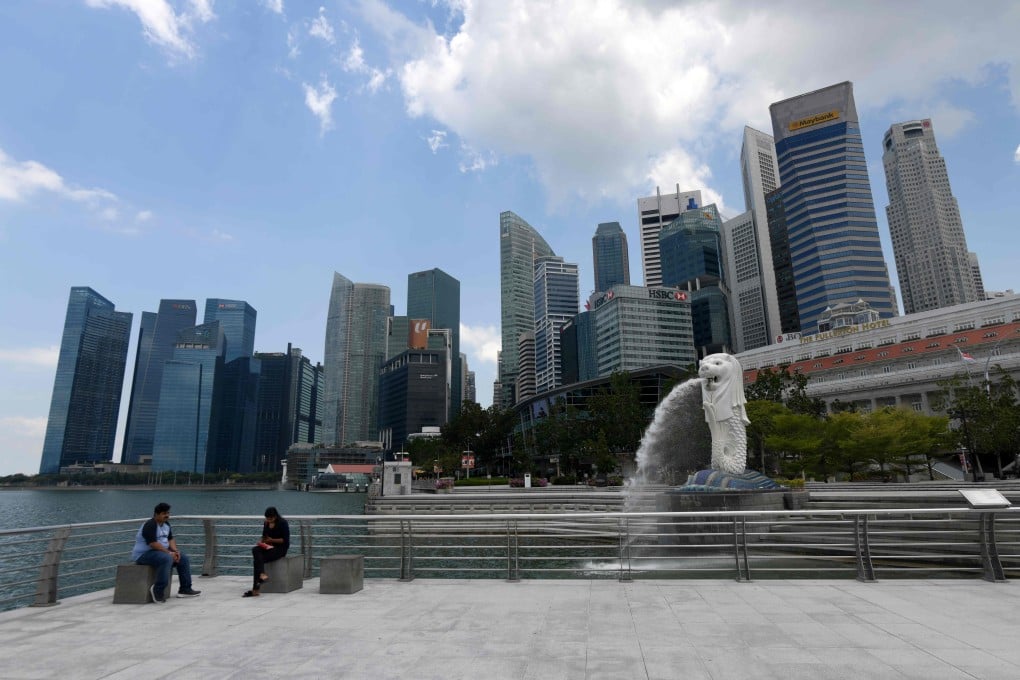 People sit near the Merlion statue in Singapore. After Jun Wei Yeo, pleaded guilty in the US to working for Chinese intelligence, Singaporeans have taken to social media to discuss the ramifications for the city state. Photo: AFP