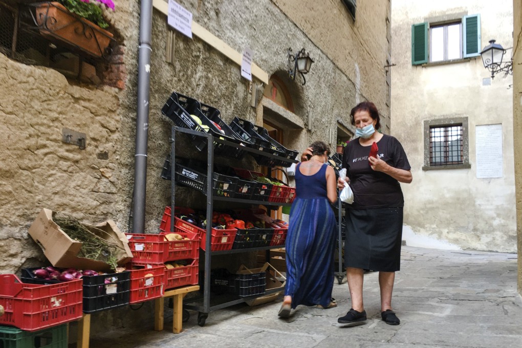 Residents of Italy’s Giglio Island shop in the steep alleys near the port. Photo: AP