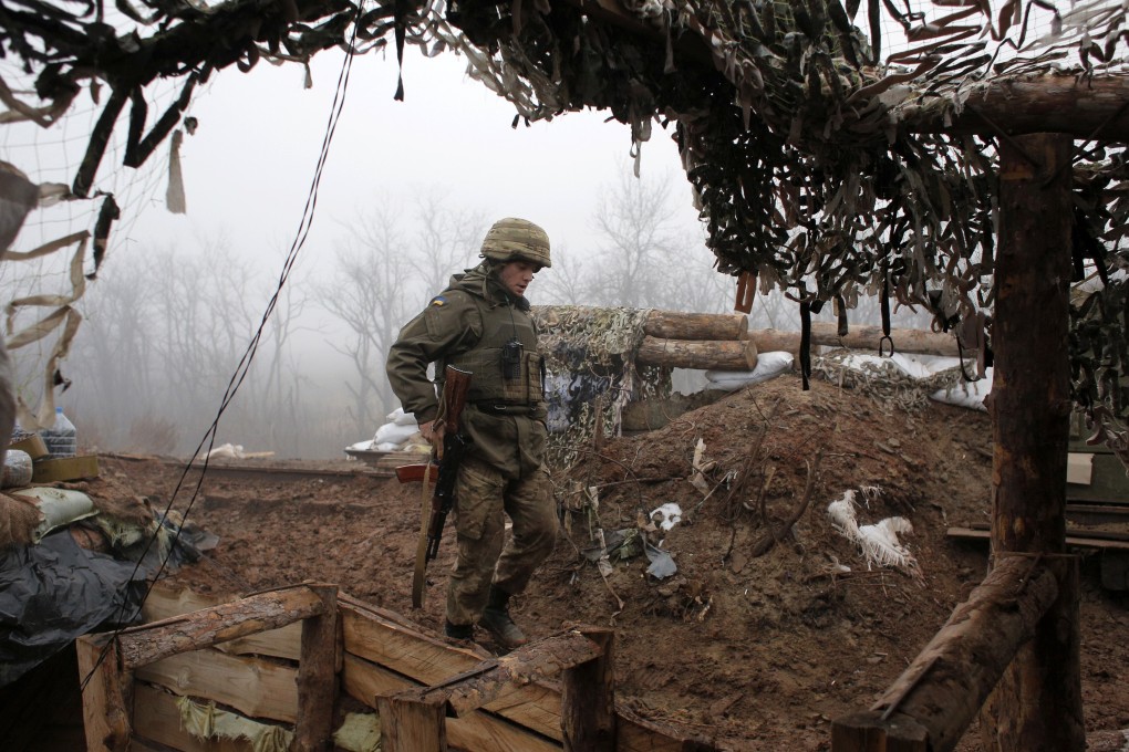 A Ukrainian soldier takes position on the front line in the Donetsk region in December 2019. Photo: AP