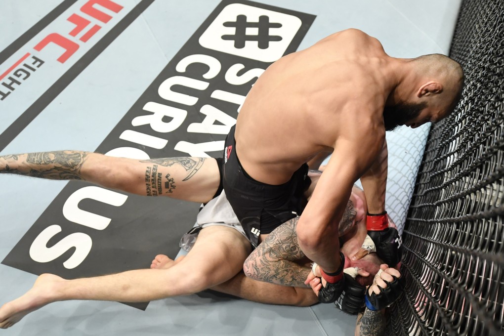 Khamzat Chimaev punches Rhys McKee in their welterweight bout during UFC Fight Night inside Flash Forum on UFC Fight Island. Photos: Jeff Bottari/Zuffa LLC via USA TODAY Sports