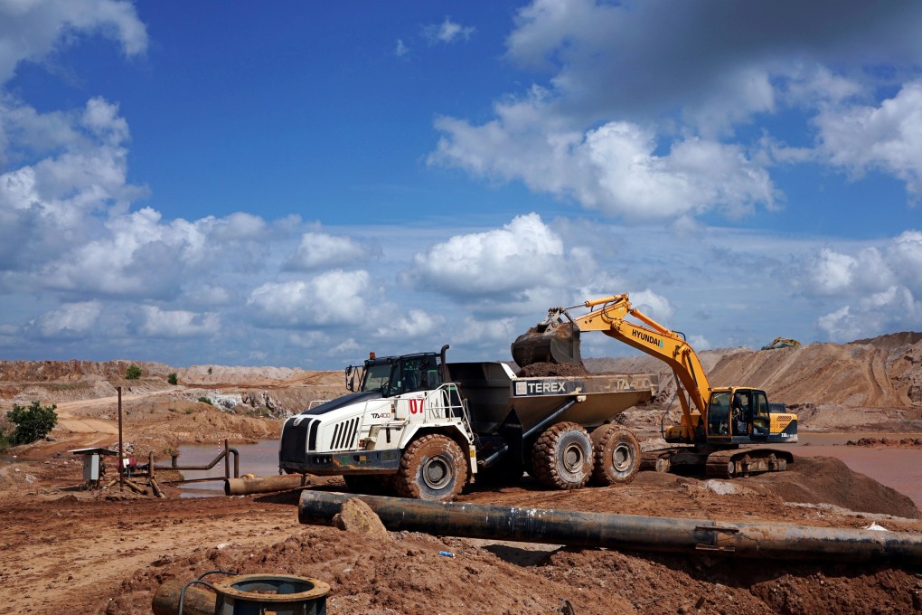 An excavator loads soil onto a truck at an open pit mine in Indonesia in this 2019 file photo. Photo: Reuters