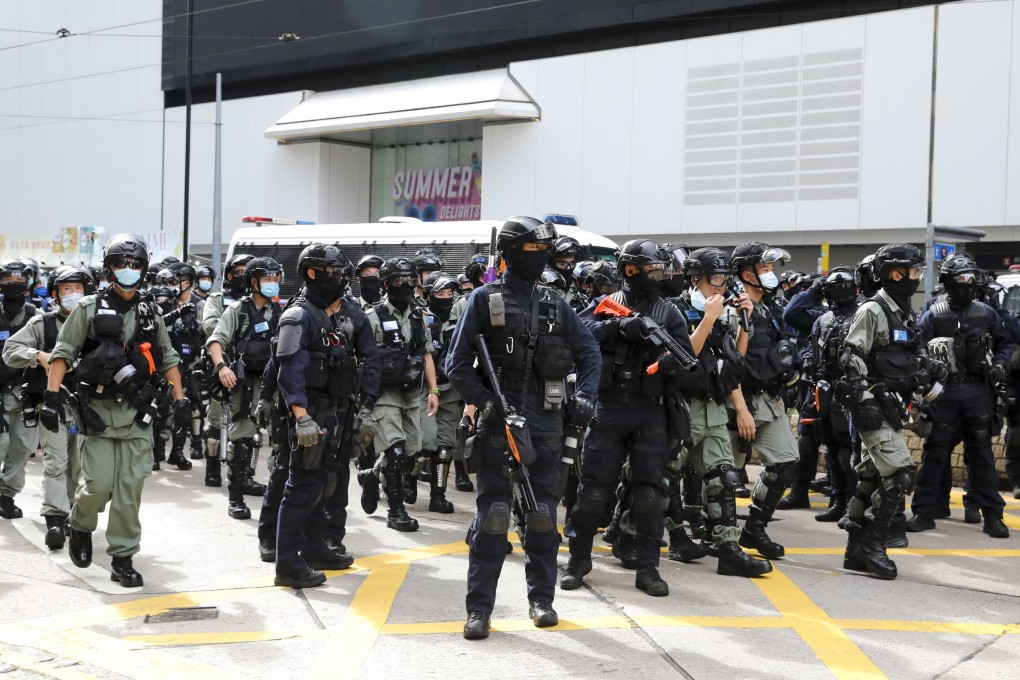 Police officers approach protesters during a demonstration in Causeway Bay on July 1. The resurgence in Covid-19 cases in recent weeks has raised pointed questions around the amount of government resources still devoted to quelling protests. Photo: Dickson Lee