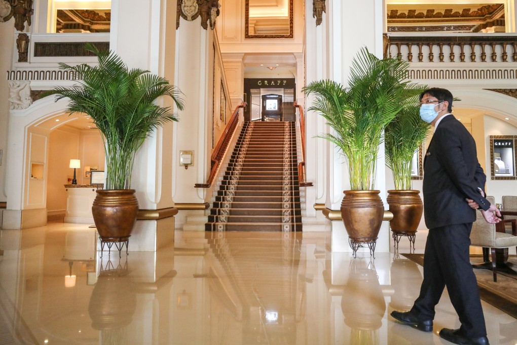 A hotel staff in surgical mask at The Peninsula Hong Kong hotel in Tsim Sha Tsui. Hong Kong’s hotel industry has been hit hard by the coronavirus pandemic, with tourist arrivals to the city falling to zero. Photo: Nora Tam