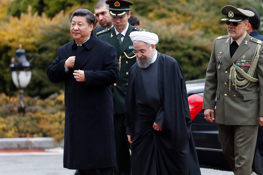 Chinese President Xi Jinping is welcomed to the presidential palace in Tehran by Iranian President Hassan Rowhani on January 23, 2016. The foundations for the China-Iran trade and military deal were laid during this visit. Photo: EPA