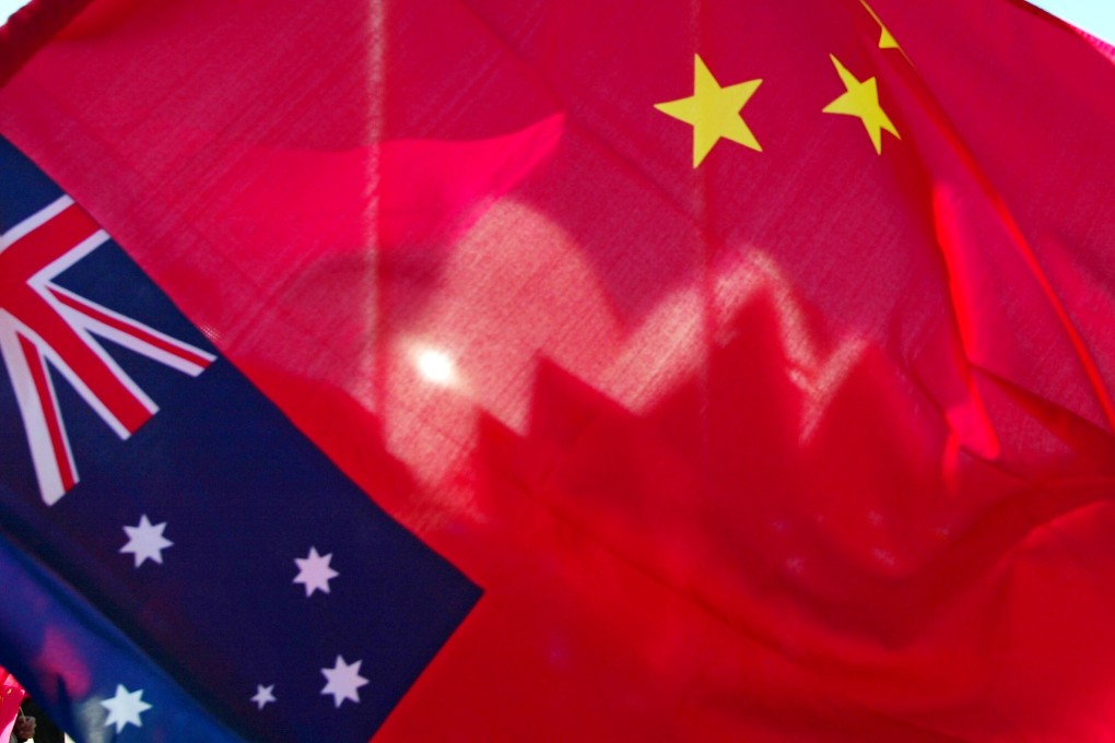 The shells of Sydney Opera House as seen through a Chinese flag. Photo: AFP