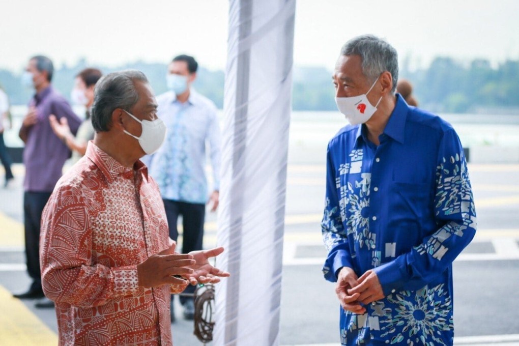 Malaysia Prime Minister Muhyiddin Yassin with Singapore Prime Minister Lee Hsien Loong at a ceremony held on the causeway between the two countries to mark the renewal of an agreement on the Rapid Transit System metro link. Photo: Kenali Johor Jom / Facebook