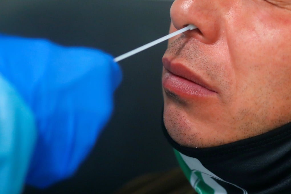 A traveller gets a nose swab for a voluntary Covid-19 test at the airport in Düsseldorf, Germany on Tuesday. Photo: Reuters
