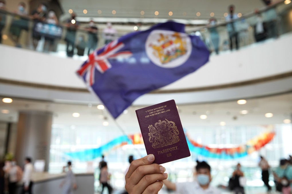 A protester holds a British National (Overseas) passport during a demonstration at the IFC shopping centre in Central on May 29. Photo: Winson Wong