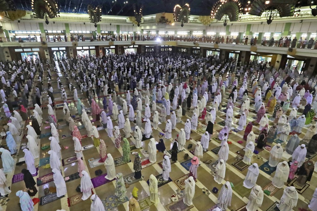 Muslims pray spaced apart as a precaution against the coronavirus outbreak during an Eid al-Adha prayer at a mosque in Jakarta, Indonesia. Photo: AP