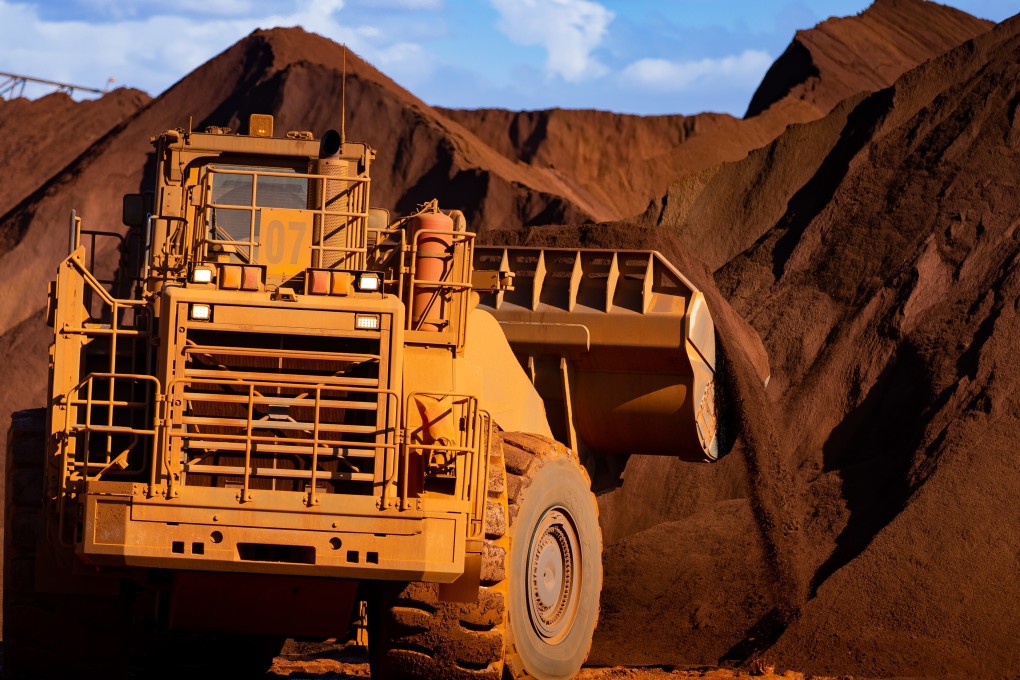 Excavators move iron ore at Port Hedland in Australia. Photo: Bloomberg
