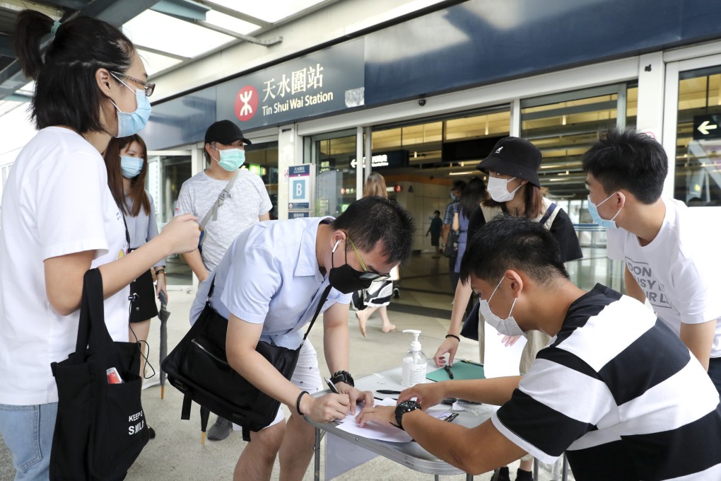 Opposition activists collect support from registered voters ahead of nomination deadline for the Legislative Council elections. Photo: Edmond So