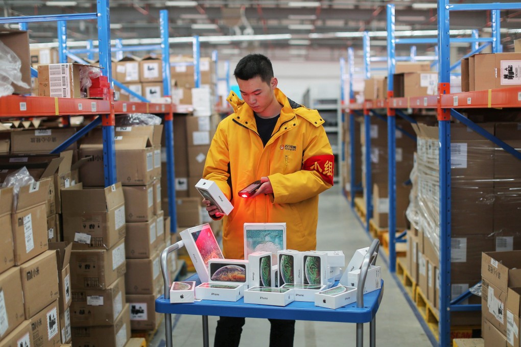 A worker prepares iPhones for delivery at a Suning storage facility in Shenyang in China's northeastern Liaoning province. Photo: STR / AFP