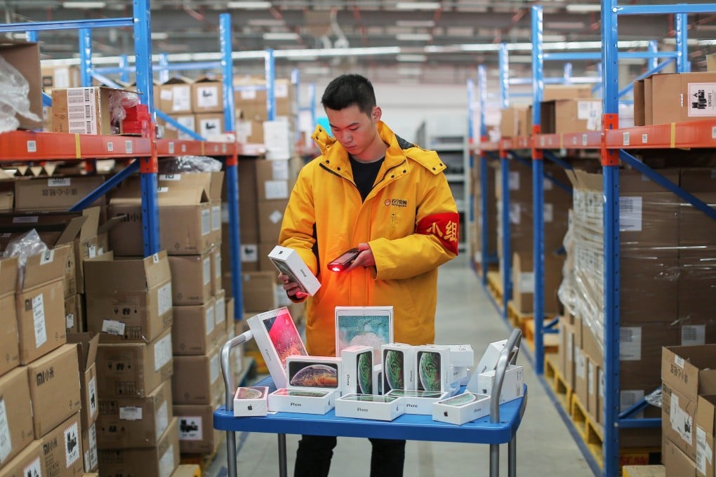 A worker prepares iPhones for delivery at a Suning storage facility in Shenyang in China's northeastern Liaoning province. Photo: STR / AFP
