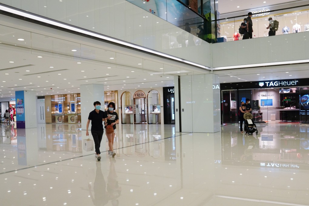 Shoppers on face masks walk through a virtually deserted Harbour City shopping mall in Tsim Sha Tsui. Photo: Sam Tsang