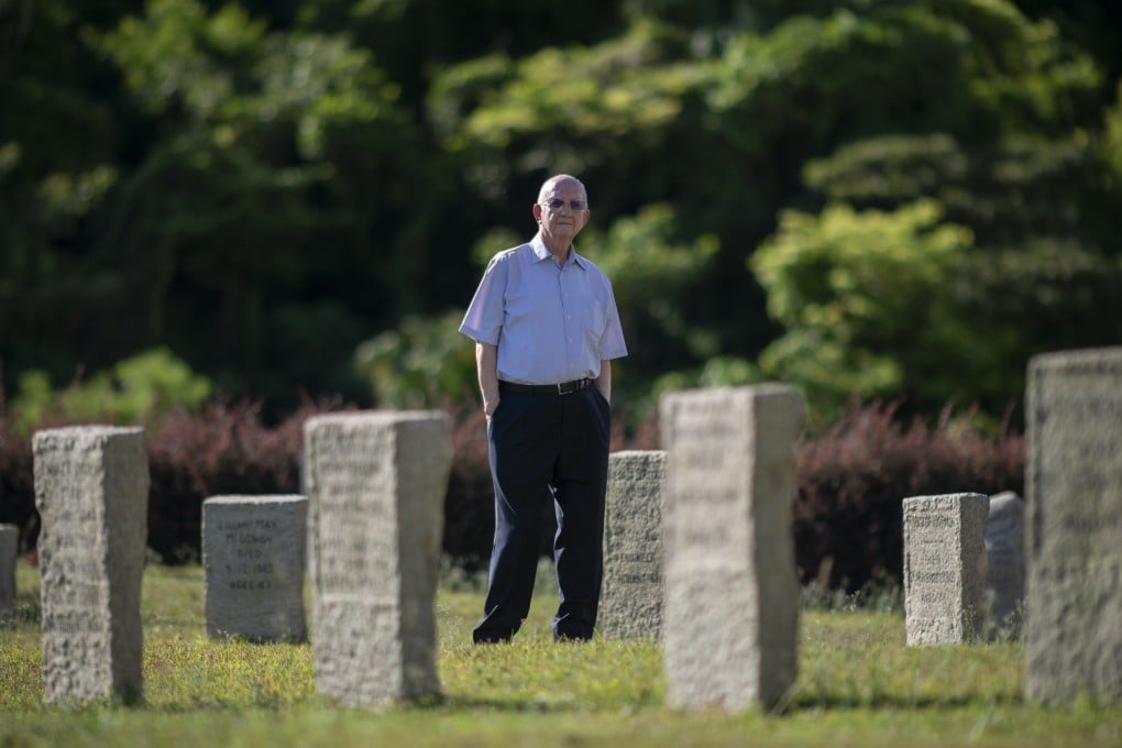 George Cautherley standing amongst the rough cut grave stones of those who died at the Stanley internment camp during the Japanese occupation of Hong Kong. Photo: SCMP / Antony Dickson