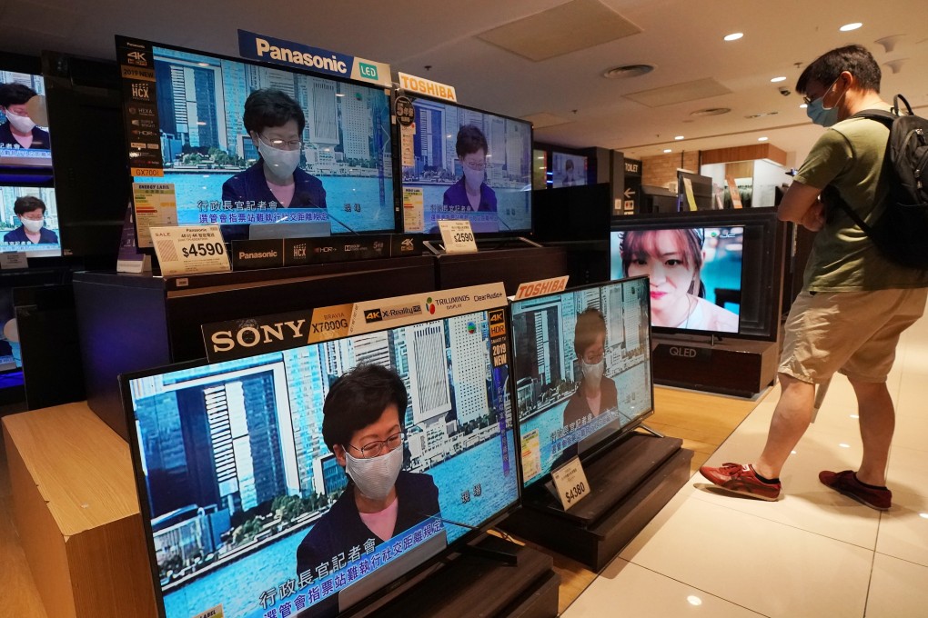 A man watches the live broadcast of Hong Kong Chief Executive Carrie Lam Cheng Yuet-ngor announcing the one-year postponement of the Legislative Council elections. Photo: Felix Wong