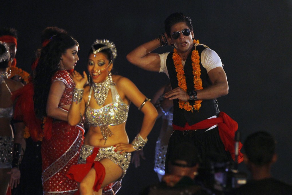 Bollywood and the Indian Premier League are intertwined. Actor Shahrukh Khan (right) performs during an opening ceremony in Chennai. Photo: AP