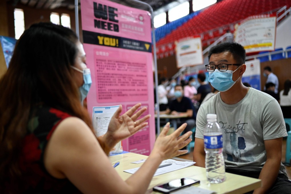 A jobseeker speaks to a recruiter at an employment fair in the central China city of Zhengzhou. Photo: AFP