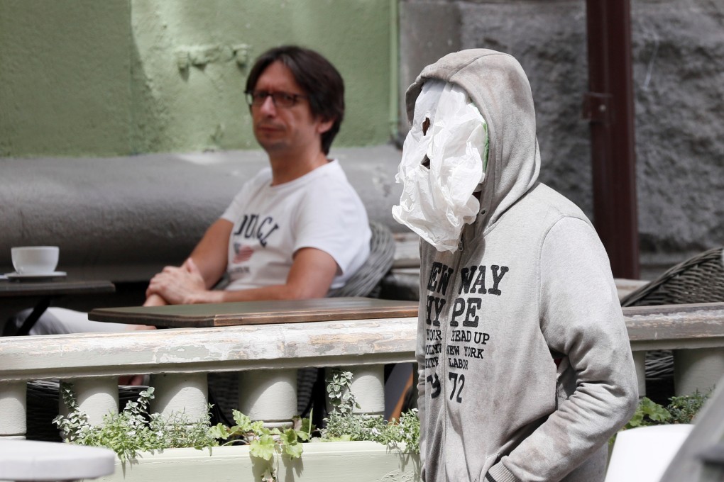 A man uses a plastic bag as a face mask in Kiev, Ukraine. Photo: Reuters