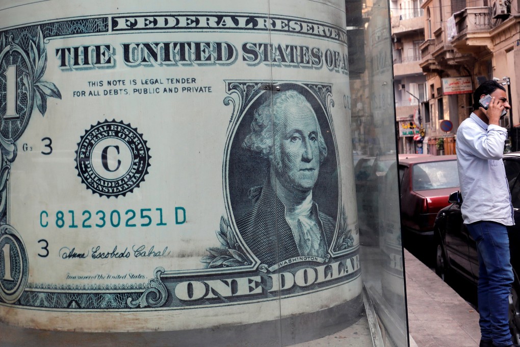 An image of a US dollar bill at a currency exchange bureau in Cairo. The dollar is losing its lustre against gold, silver and other key currencies. Photo: Reuters
