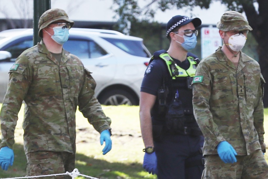 Australian Defence Force personnel and Victorian police patrol in Melbourne, where a night curfew has bee ordered. Photo: DPA