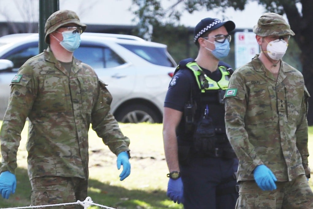 Australian Defence Force personnel and Victorian police patrol in Melbourne, where a night curfew has bee ordered. Photo: DPA