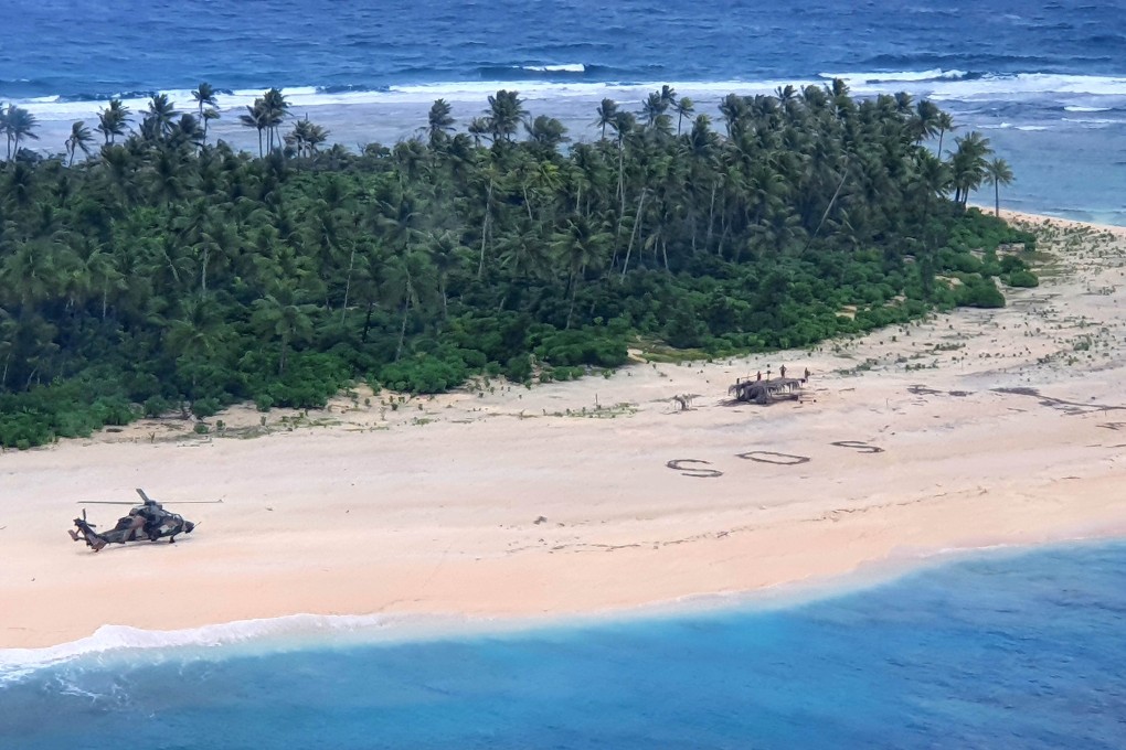 An Australian Army helicopter lands near the sailors’ SOS sign on Pikelot Island. Photo: Handout via Reuters