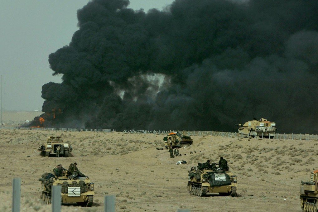 Coalition tank and armoured personnel carrier crews wait on the front line near the city of Basra in southern Iraq in 2003. Robert Draper’s new book, To Start a War: How the Bush Administration Took America Into Iraq, delves into the reasons behind the disastrous Iraq war. Photo: Reuters
