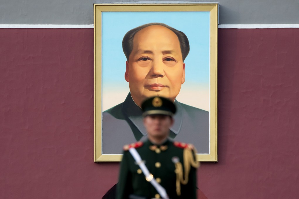 A Chinese paramilitary policeman stands guard on Tiananmen Square in front of the portrait of Mao Zedong in Beijing. Photo: AFP