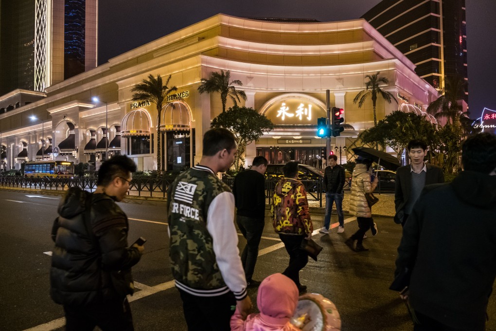 Pedestrians crossing a road outside the Wynn Macau resort. The concessionaire recorded its worst quarterly results in the quarter to June 30, 2020 as the coronavirus chokes the industry. Photo: Bloomberg