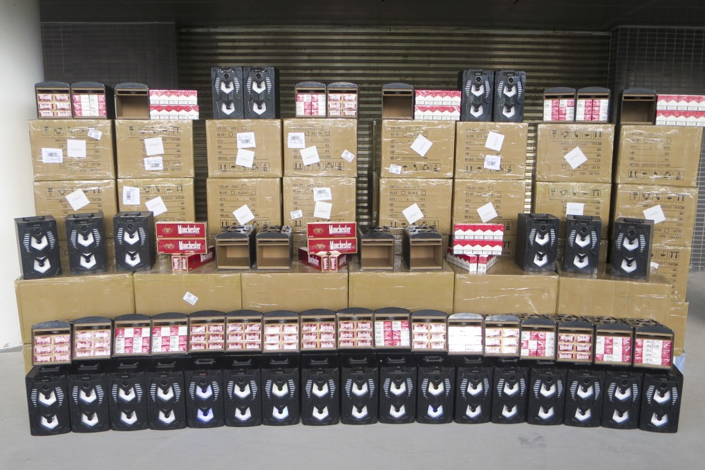 Customs authorities display some HK$1.7 million worth of contraband cigarettes found concealed in hi-fi speakers on Tuesday. Photo: Handout