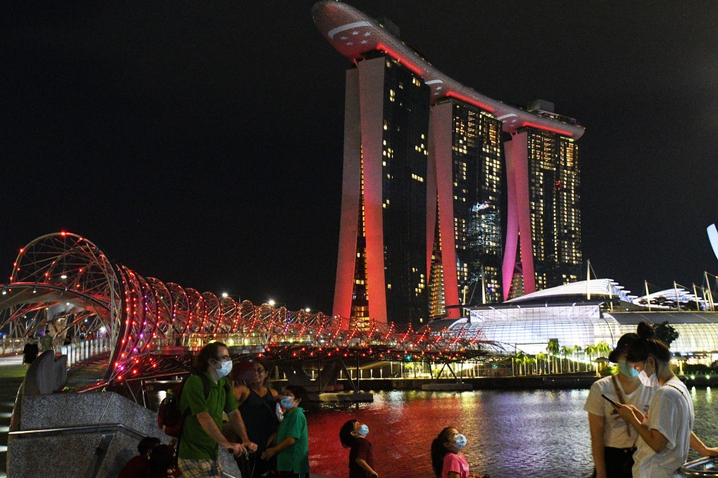 Red and white lights light up the Marina Bay Sands and Helix Bridge as part of the upcoming celebrations for Singapore’s National Day. Photo: Xinhua