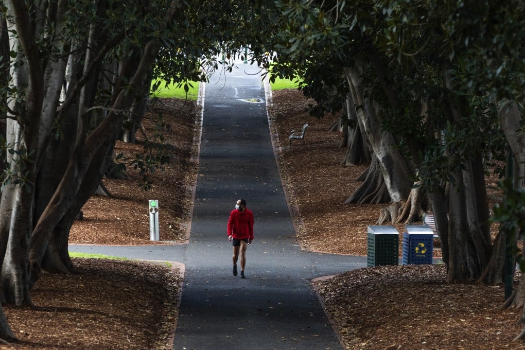 A man wearing a mask walks in a Melbourne park. Photo: AP