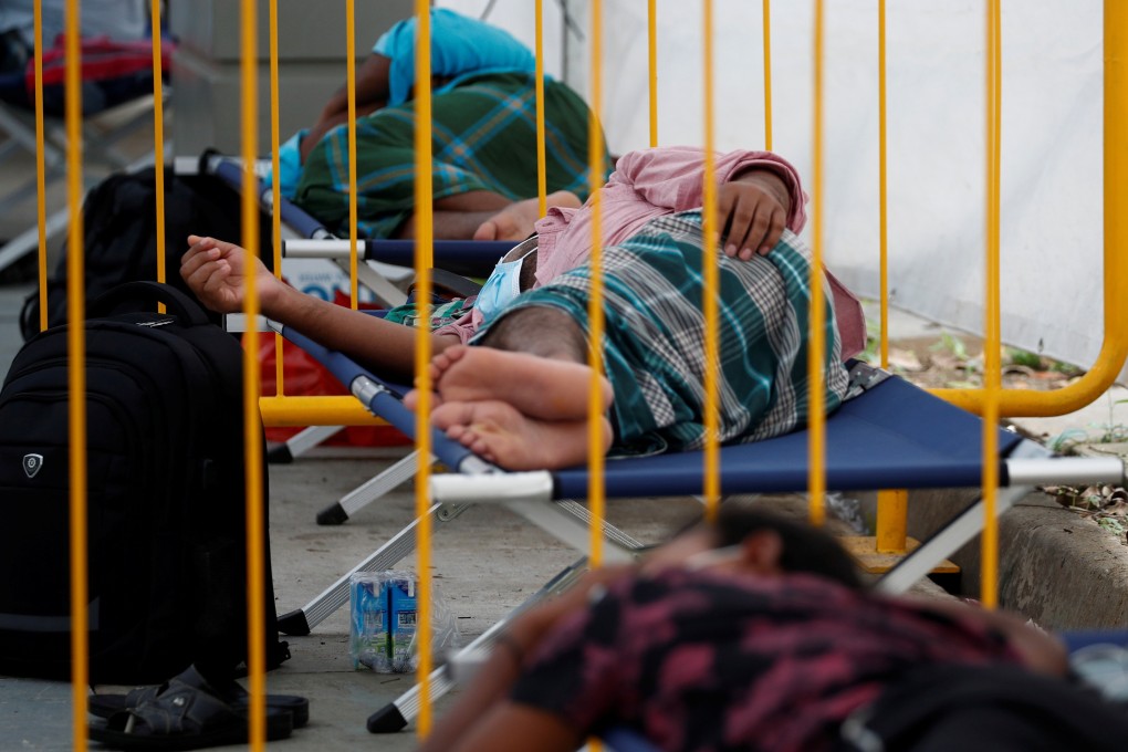 Migrant workers rest at an isolation facility in a dormitory as they wait for the results of their coronavirus tests in May. Photo: Reuters