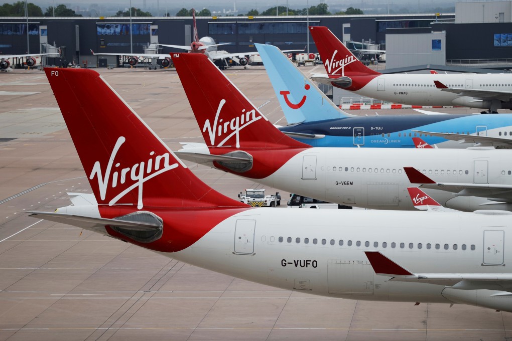 FILE PHOTO: Virgin Atlantic and TUI Airways aircraft are seen at Manchester Airport, following the outbreak of the coronavirus disease (COVID-19), Manchester, Britain, June 8, 2020. REUTERS/Phil Noble/File Photo