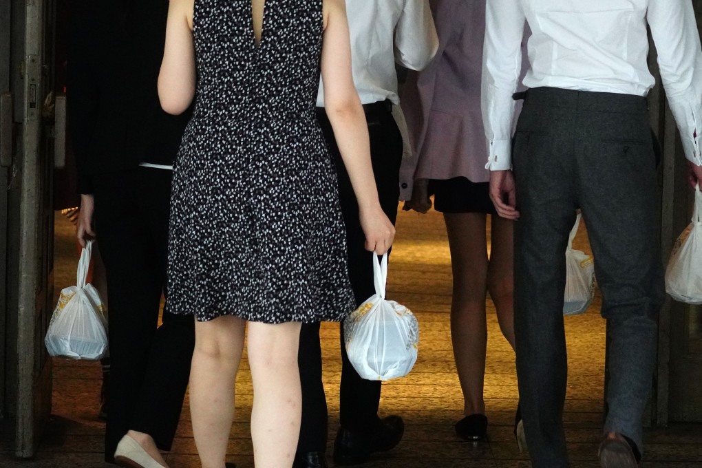 Office-workers carry takeaway meals in Admiralty on July 31. Hongkongers are estimated to be throwing away more than 100 million pieces of disposable cutlery and plastic bags every week. Photo: Sam Tsang