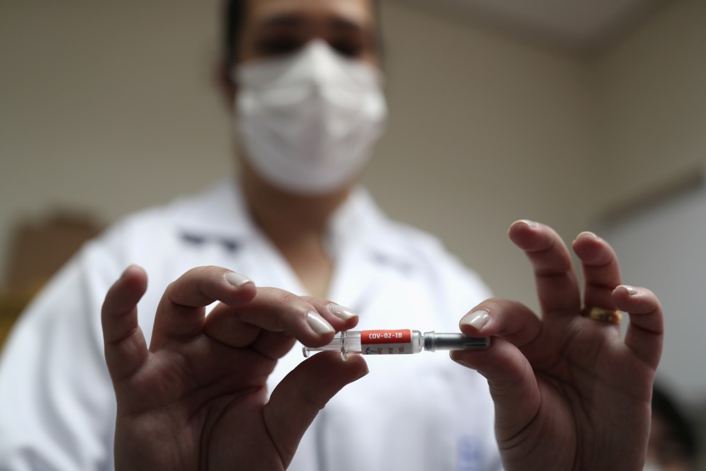 A nurse holds a potential vaccine from China’s SinoVac before administering it during trials in Brazil. Photo: Reuters