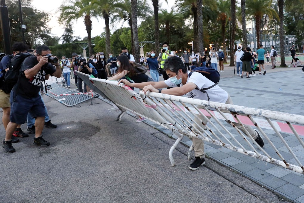 Attendees of a banned Tiananmen Square vigil at Victoria Park remove metal barriers surrounding the football pitch on June 4. Photo: Sam Tsang