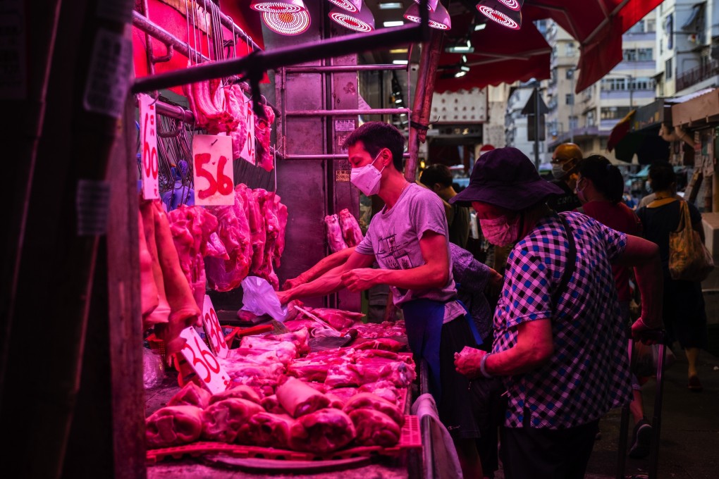 Customers wearing protective face masks browse red meat at a wet market in the Sham Shui Po district in Hong Kong, in July. Photo: Bloomberg