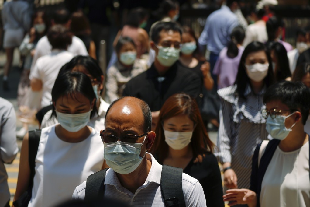 Pedestrians crossing the street during lunch time in Central on 19 May 2020. Photo: Sam Tsang