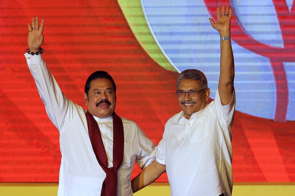 Sri Lankan Prime Minister Mahinda Rajapaksa and his brother, President Gotabaya Rajapaksa, wave to supporters. Their party secured a landslide victory in the parliamentary elections, giving them the two-thirds majority required to make constitutional changes. Photo: AP