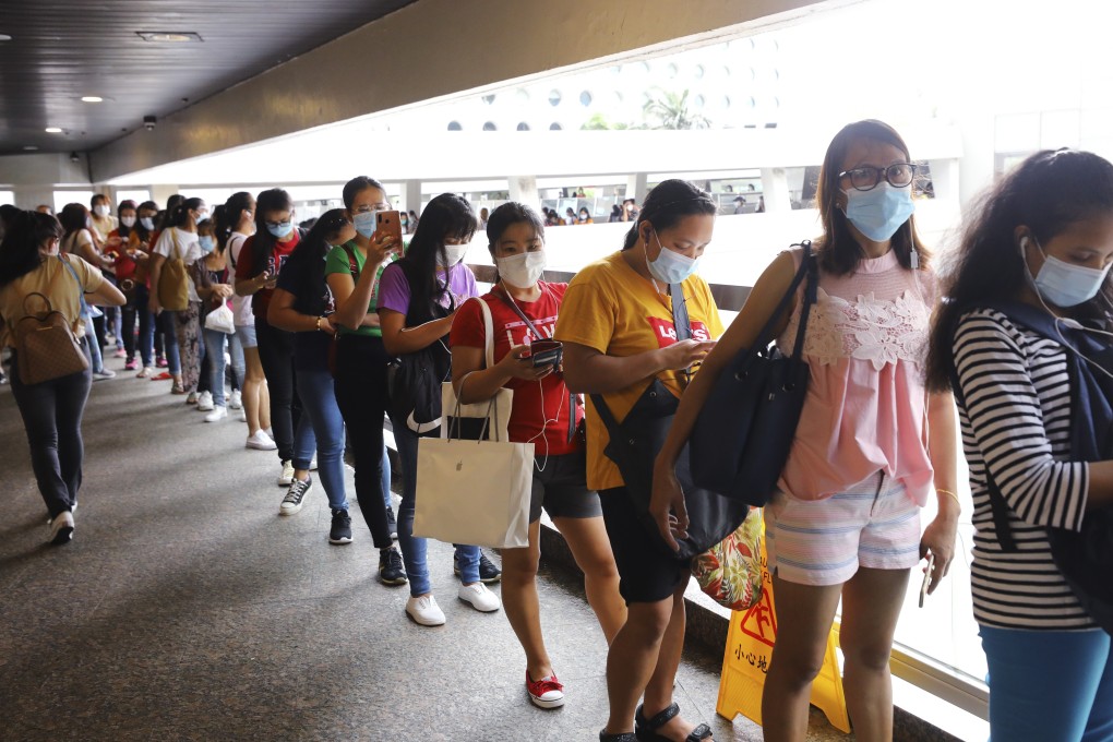 Foreign domestic helpers queue up to transfer money at World Wide House in Central earlier this month. Photo: Dickson Lee